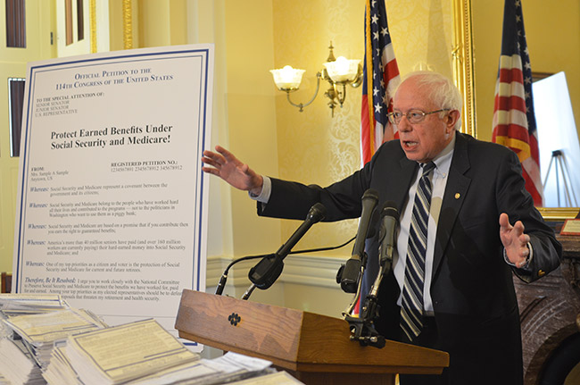 photo 1 of Sen. Bernie Sanders receiving petitions on Social Security