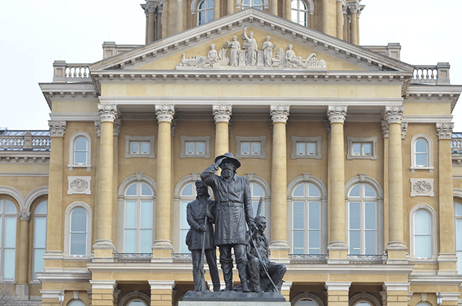 photo of the statue Pioneers of the Territory in front of the Iowa State Capitol