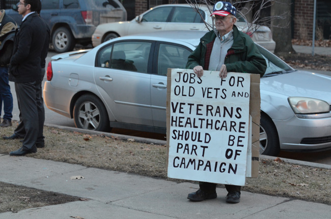 photo of veteran protesting outside the iowa freedom summit